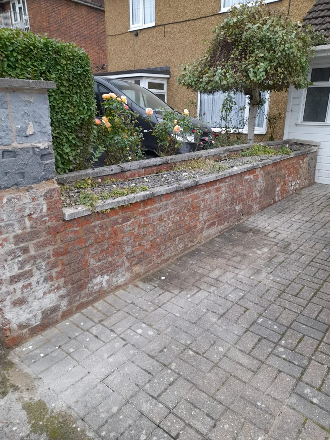 Driveway wall — old brickwork with crumbling mortar