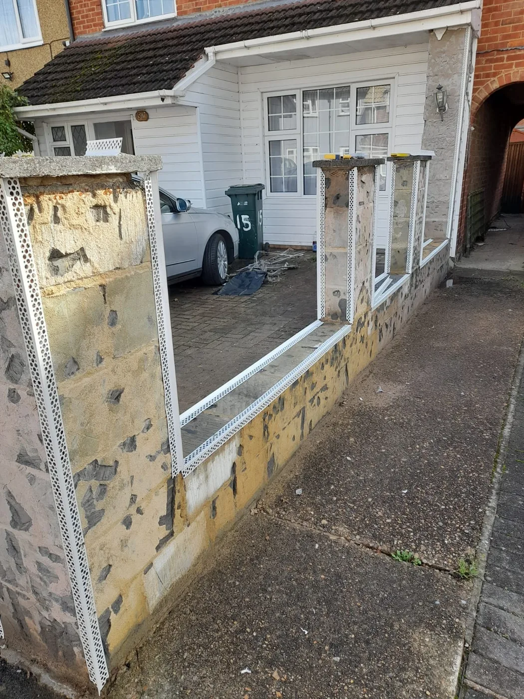 Boundary wall — stripped render and exposed stonework