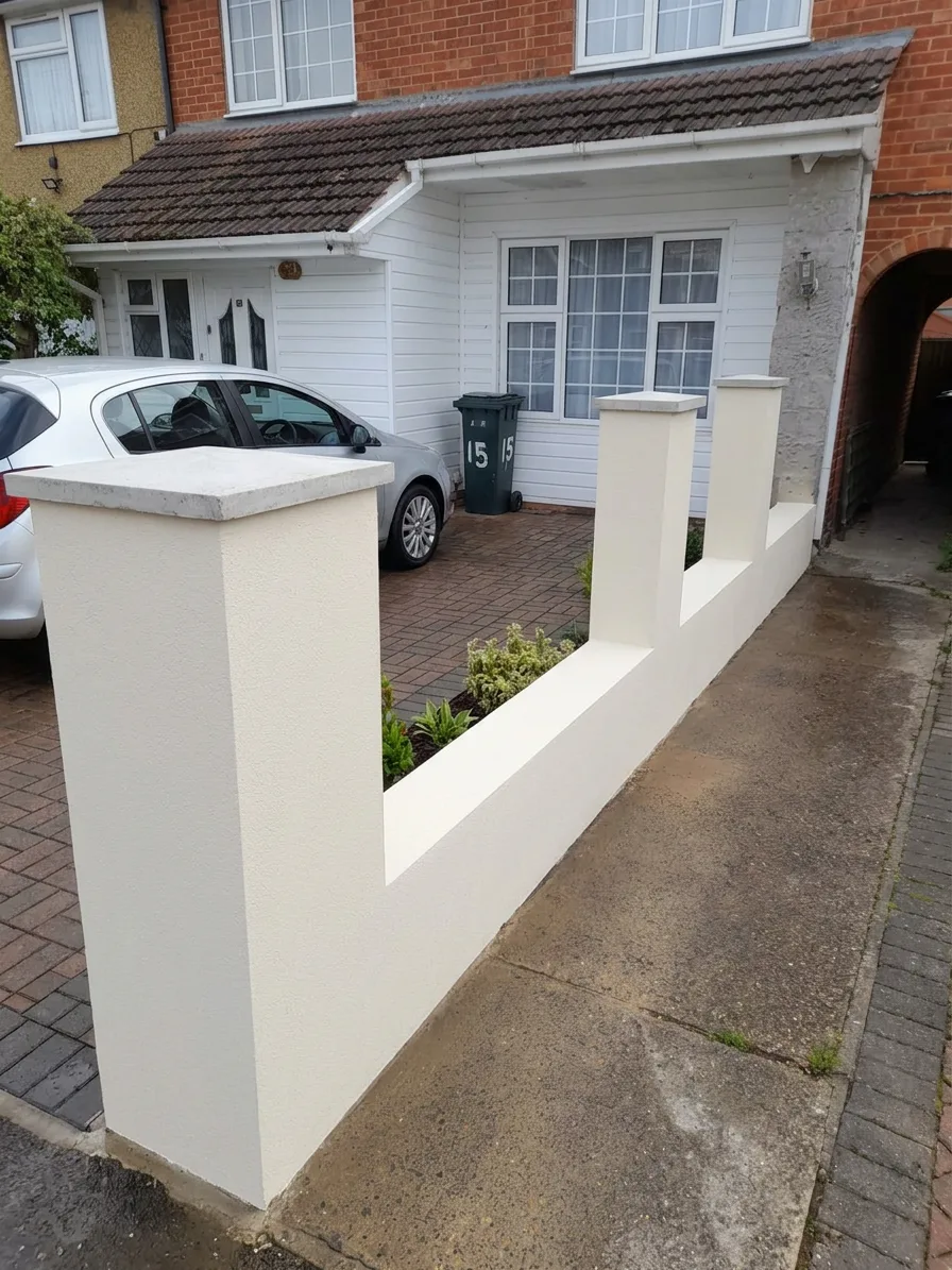 Front boundary wall — smooth rendered pillars with planting