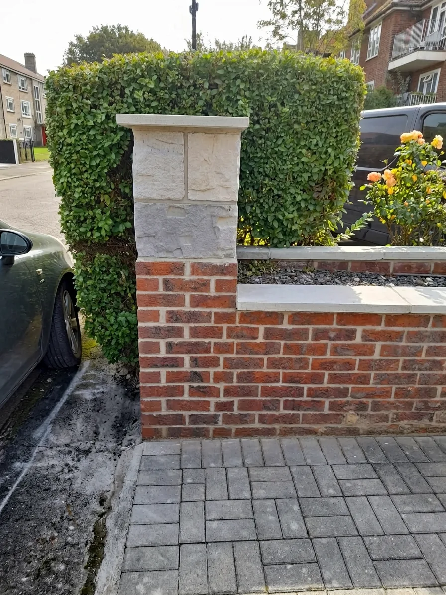 Boundary pillar — restored stonework and fresh brickwork