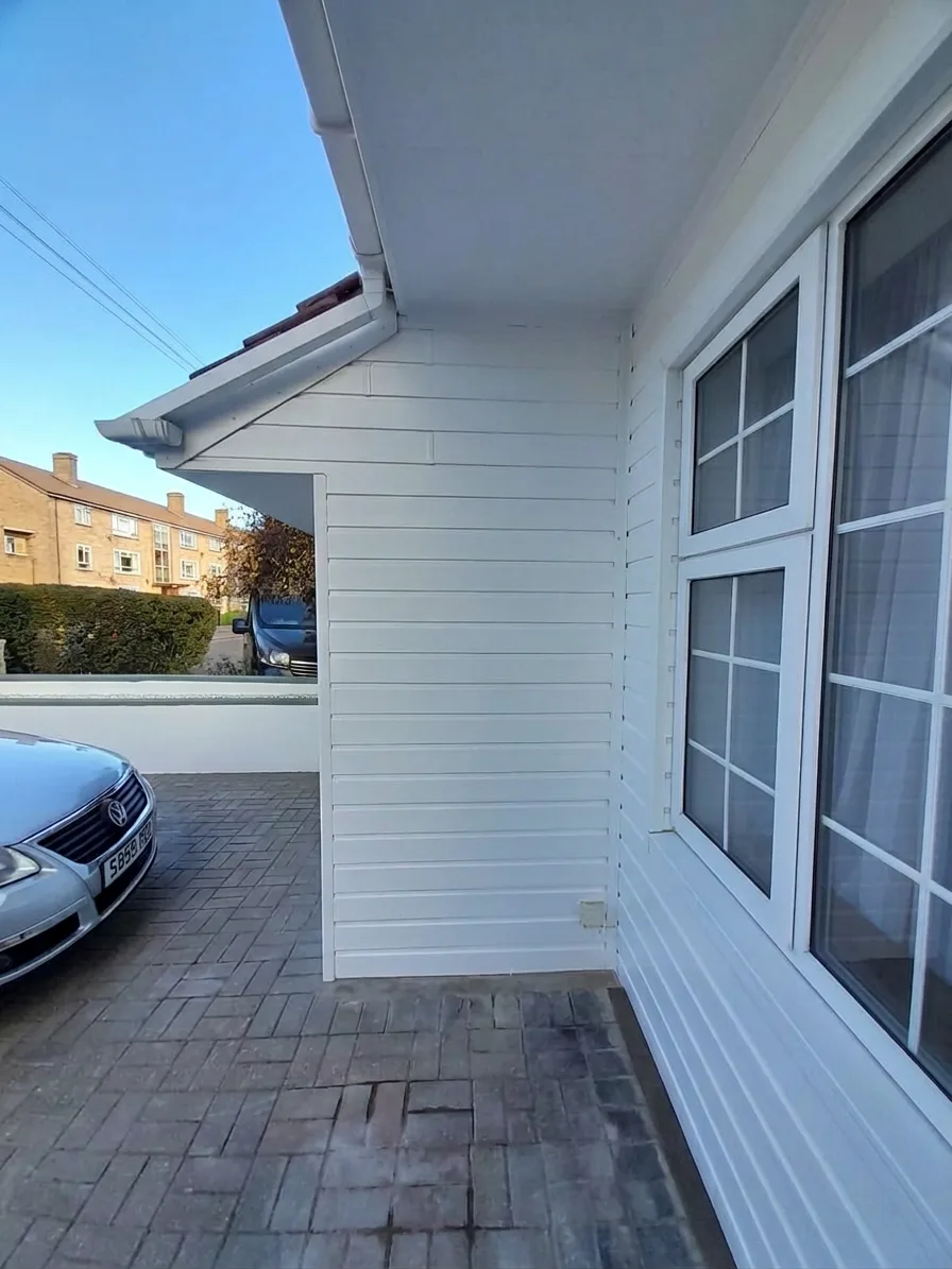 Side detail — pristine white cladding and fascia boards